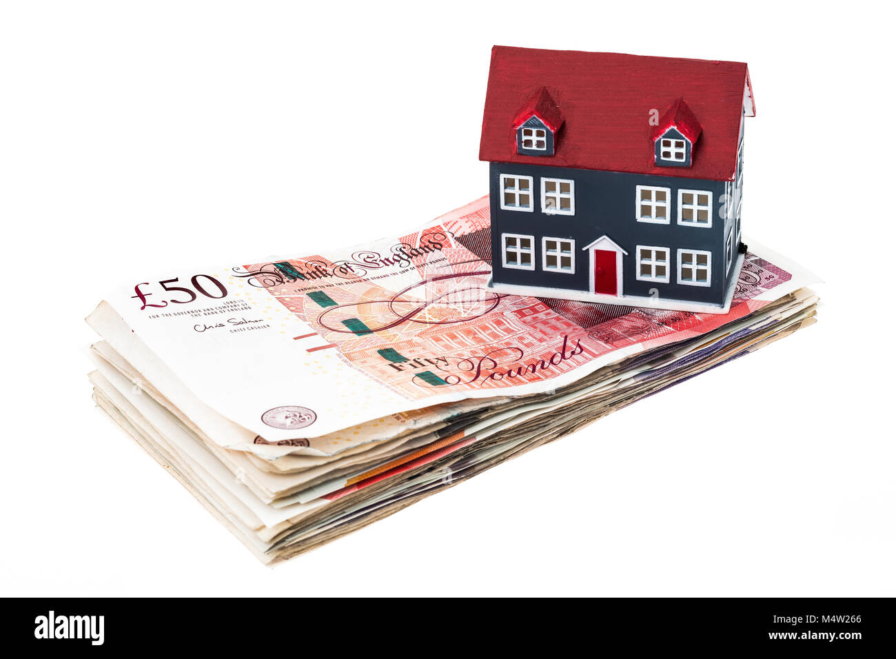 House buying concept image of UK banknotes and a house Stock Photo