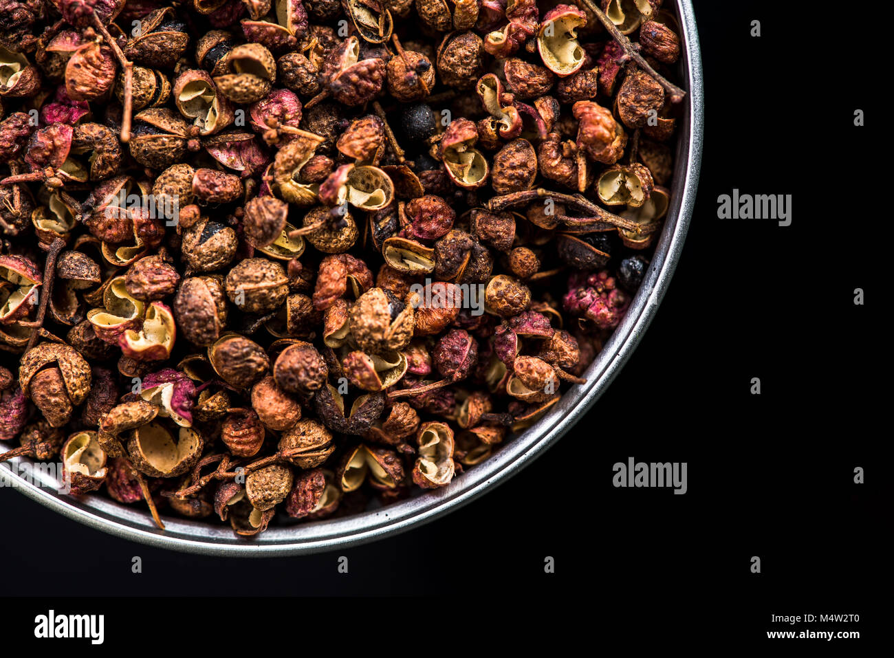 Sichuan pepper on pot on dark background with copy space. Stock Photo