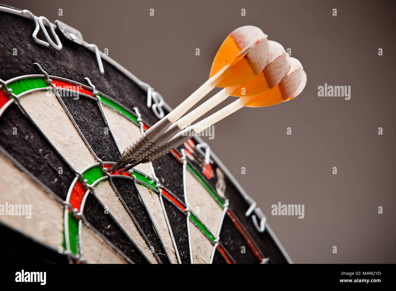 Three darts hitting perfect 180 score on dart board Stock Photo - Alamy