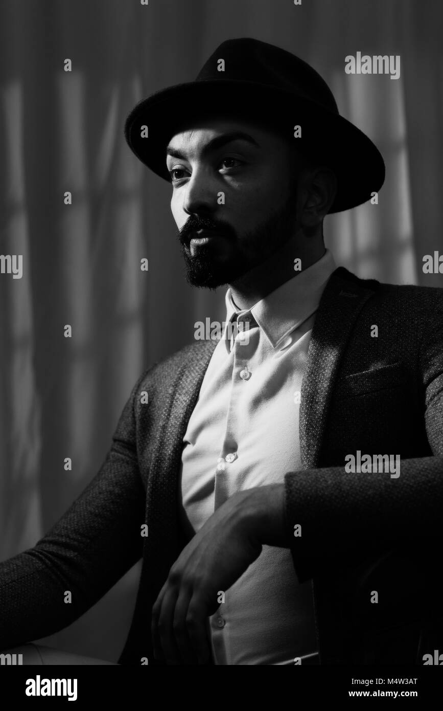 Film Noir shot of young man wearing a trilby Stock Photo