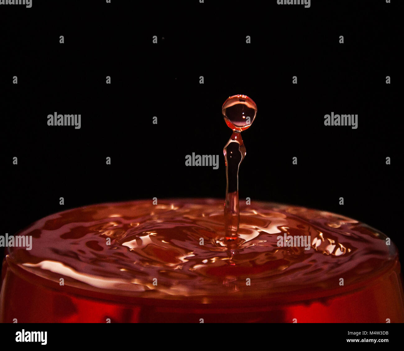 wine red drop splash black background Stock Photo