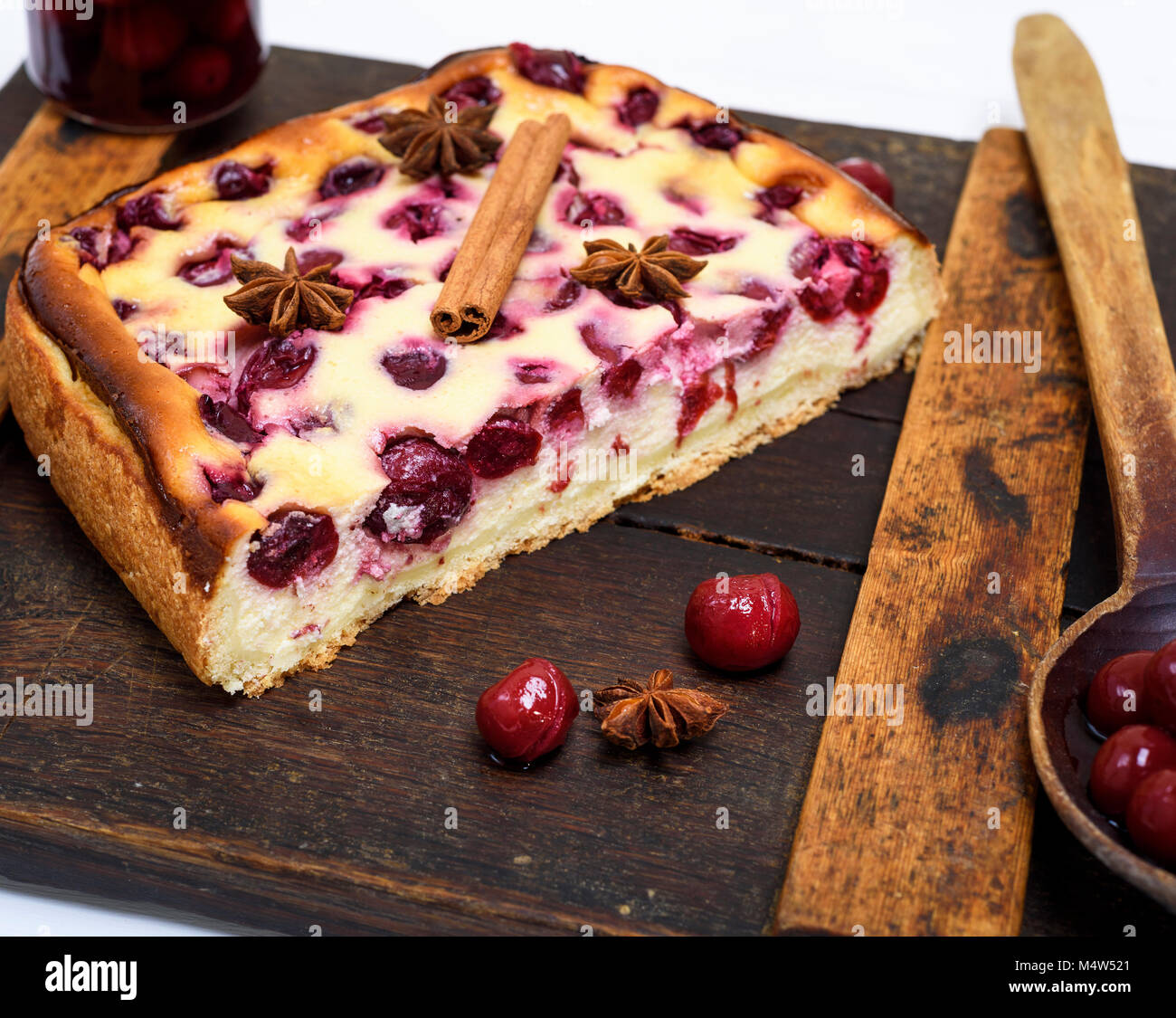 Cake Of Cottage Cheese And Red Cherries On A Brown Board Top View