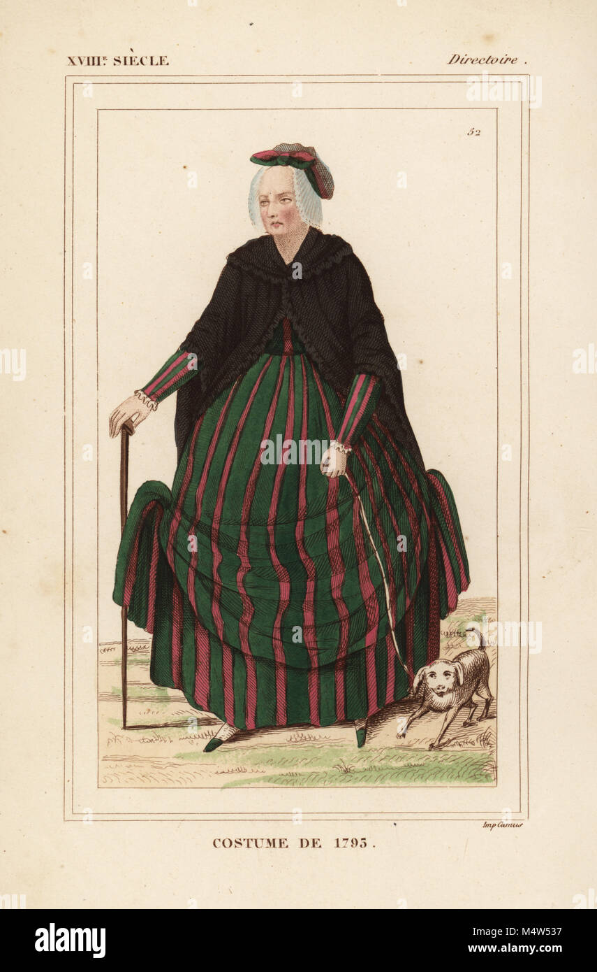 French woman's fashion, Directory era, 1795. Woman with pet dog and stick. She wears a striped dress, black mantelet, and hat of ribbons in white, pink and green. Handcoloured lithograph from Le Bibliophile Jacob aka Paul Lacroix's Costumes Historiques de la France (Historical Costumes of France), Administration de Librairie, Paris, 1852. Stock Photo