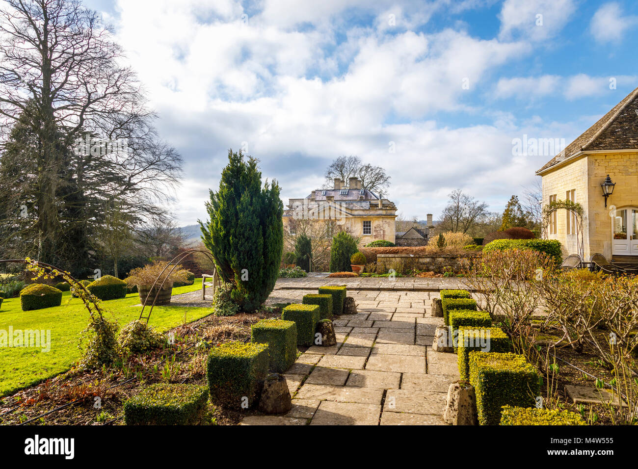 Painswick House with flagstone paved patio terrace and box hedges ...