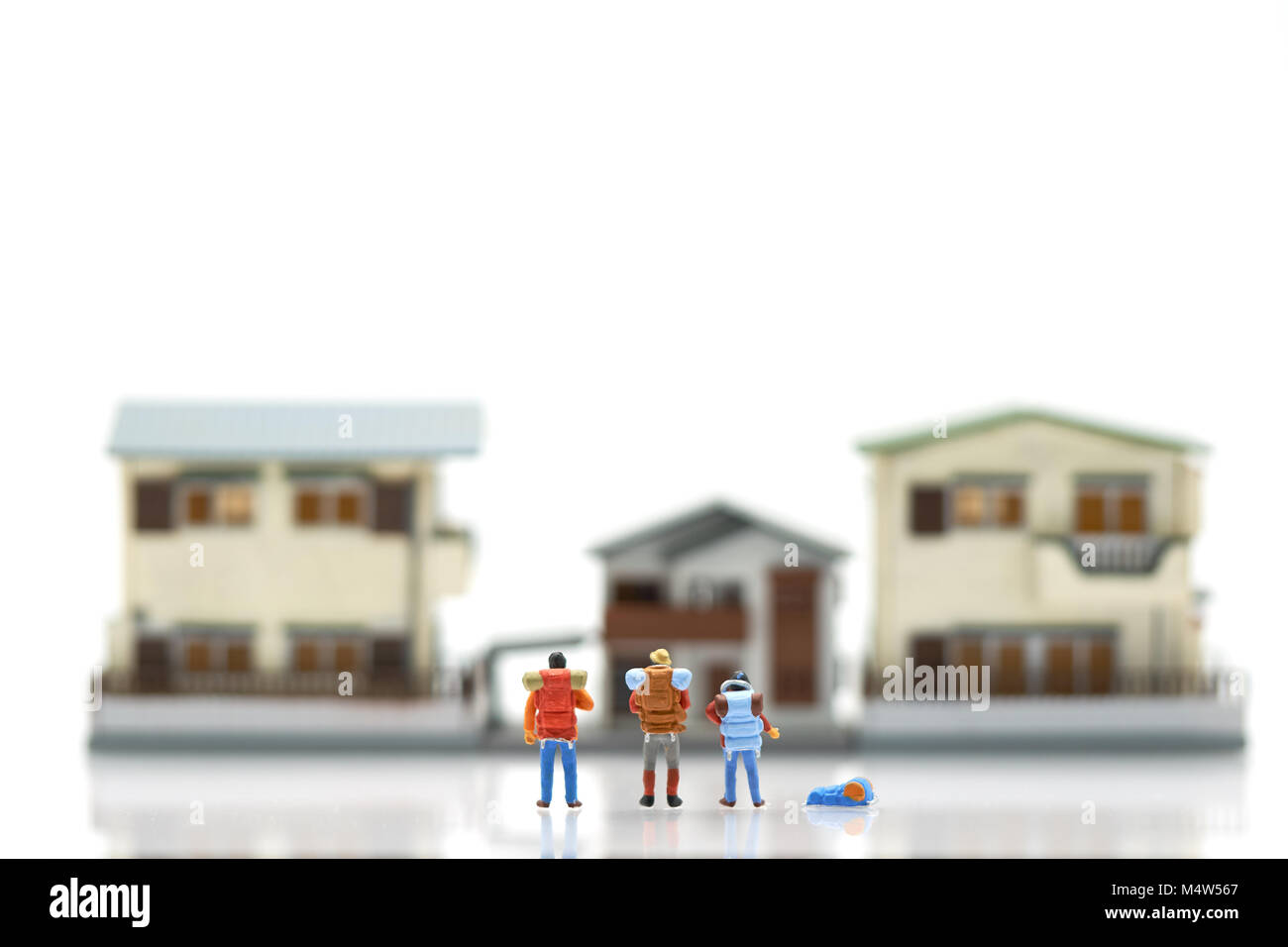 Miniature 3 people stand on House and hotel models To choose a place to live in. using as background  travel concept with copy spaces for your Stock Photo