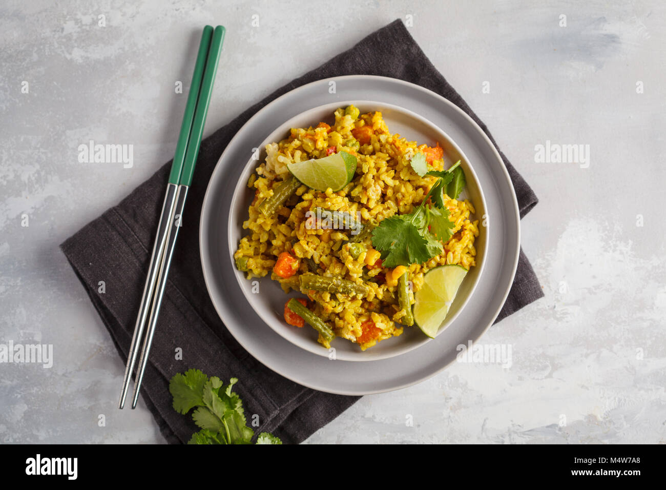 Vegetarian curry rice with vegetables in a gray plate. Healthy vegan food concept, detox. Stock Photo