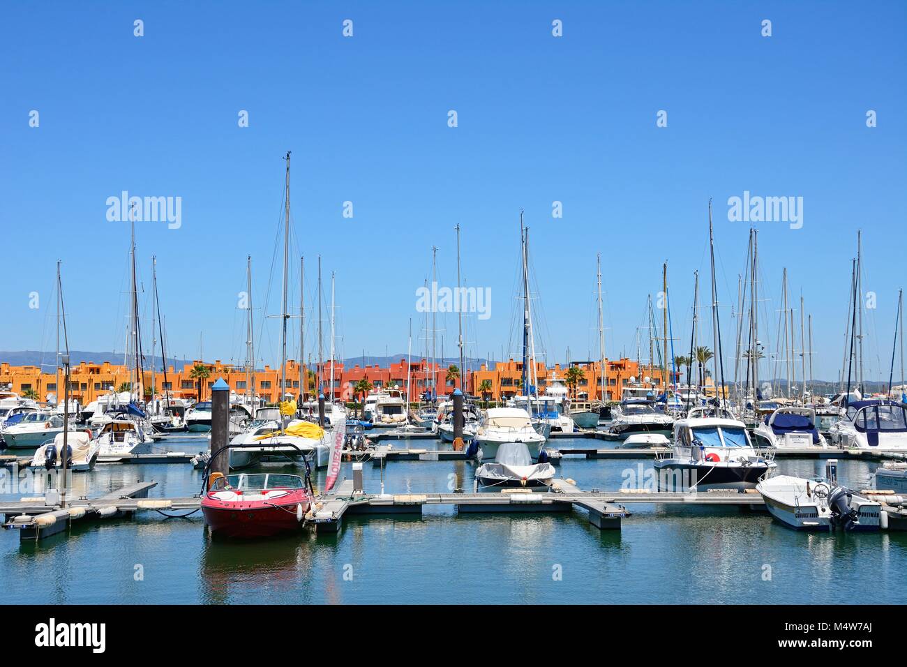 Luxury yachts and motorboats moored in the marina with apartments to the rear, Portimao, Algarve, Portugal, Europe. Stock Photo