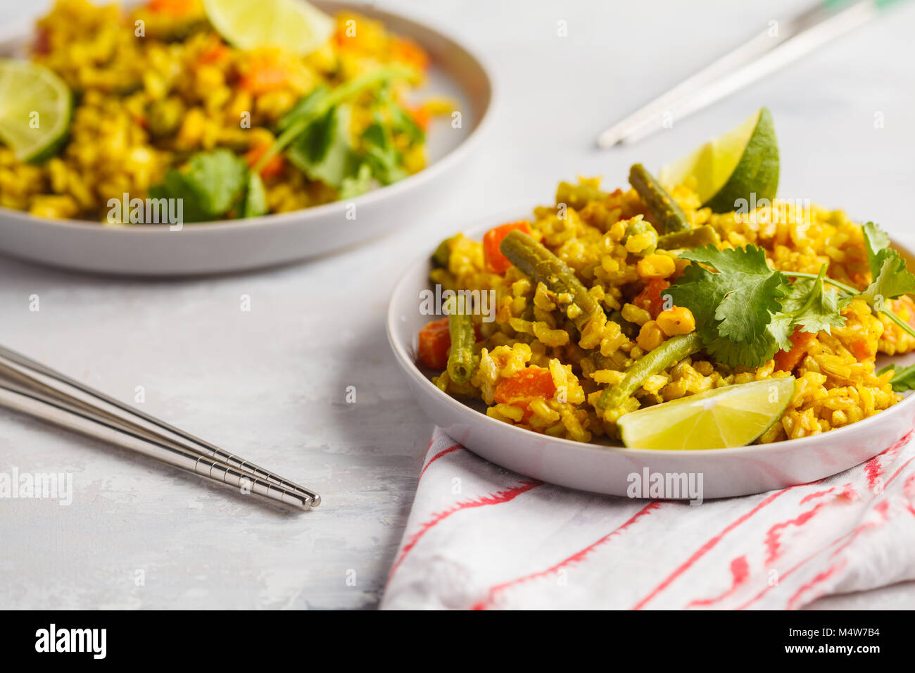 Vegetarian curry rice with vegetables and coconut cream. Healthy vegan food concept, detox, vegetable diet. Stock Photo