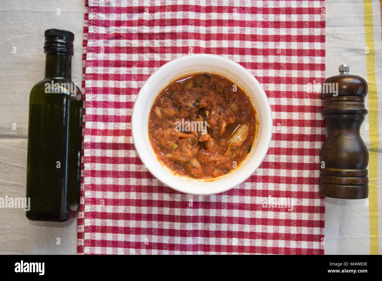top view on a bowl with dried salted cod at livornese style Stock Photo