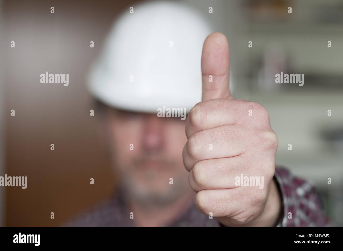 Construction worker showing hand with thumb up Stock Photo Alamy