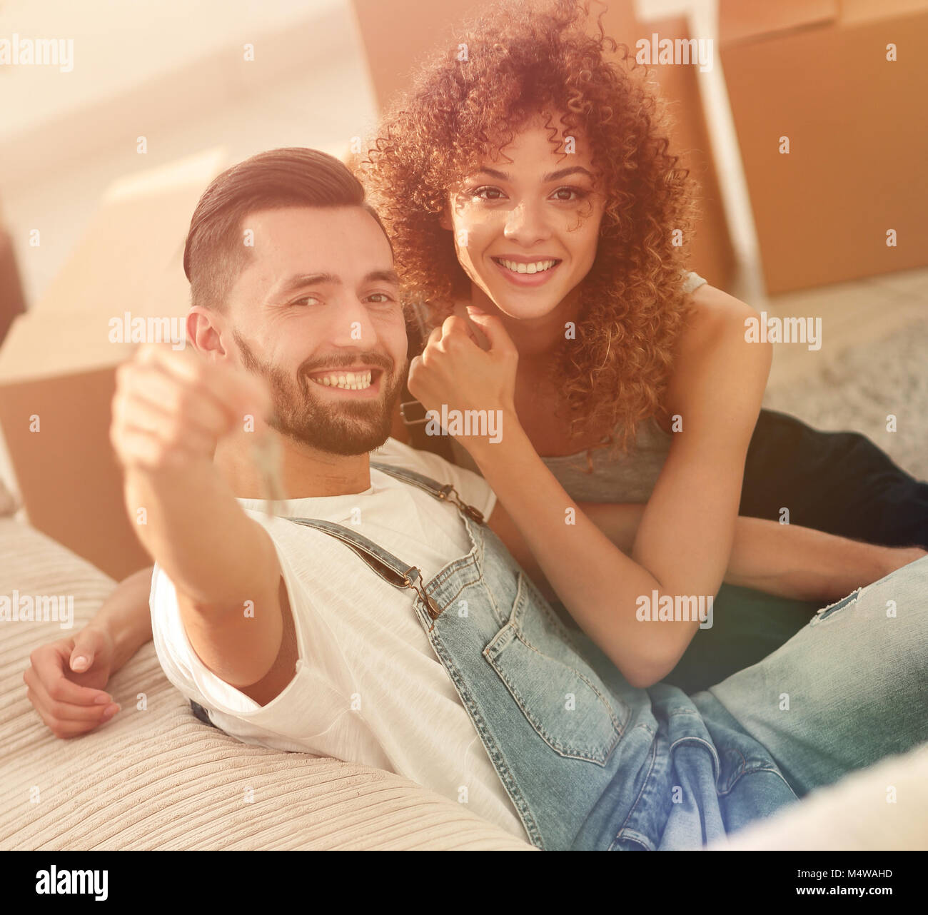 young couple holding the key to a new apartment Stock Photo - Alamy