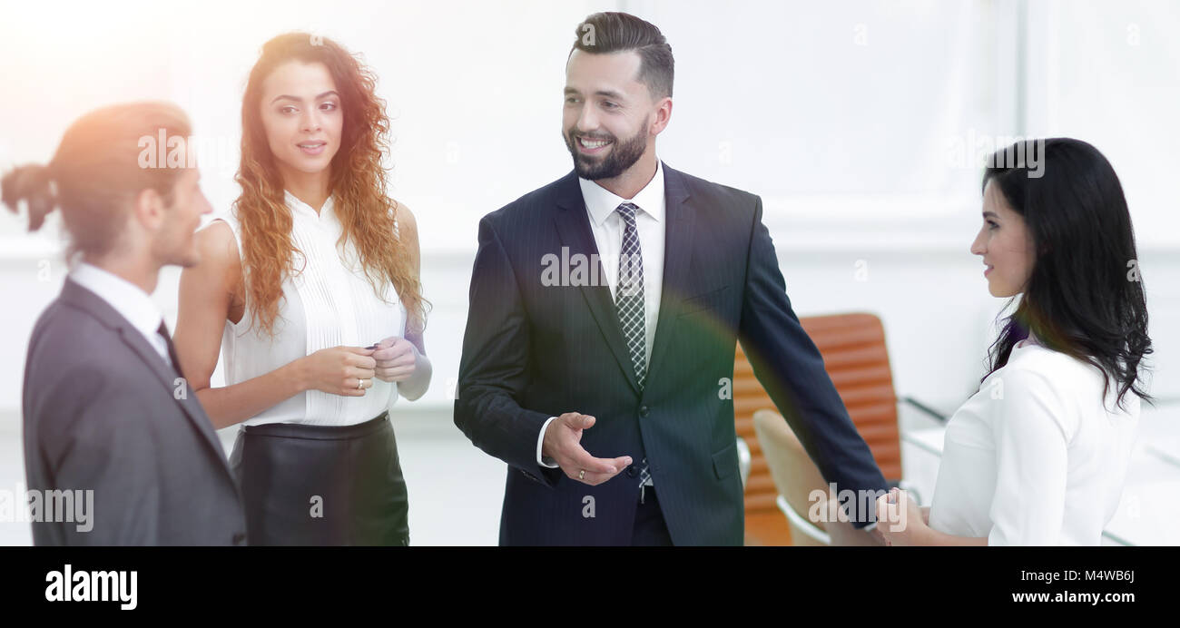 business team talking, standing in office Stock Photo - Alamy