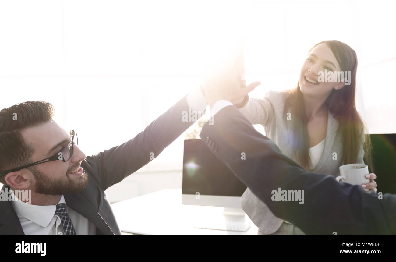 smiling colleagues giving each other high five Stock Photo - Alamy