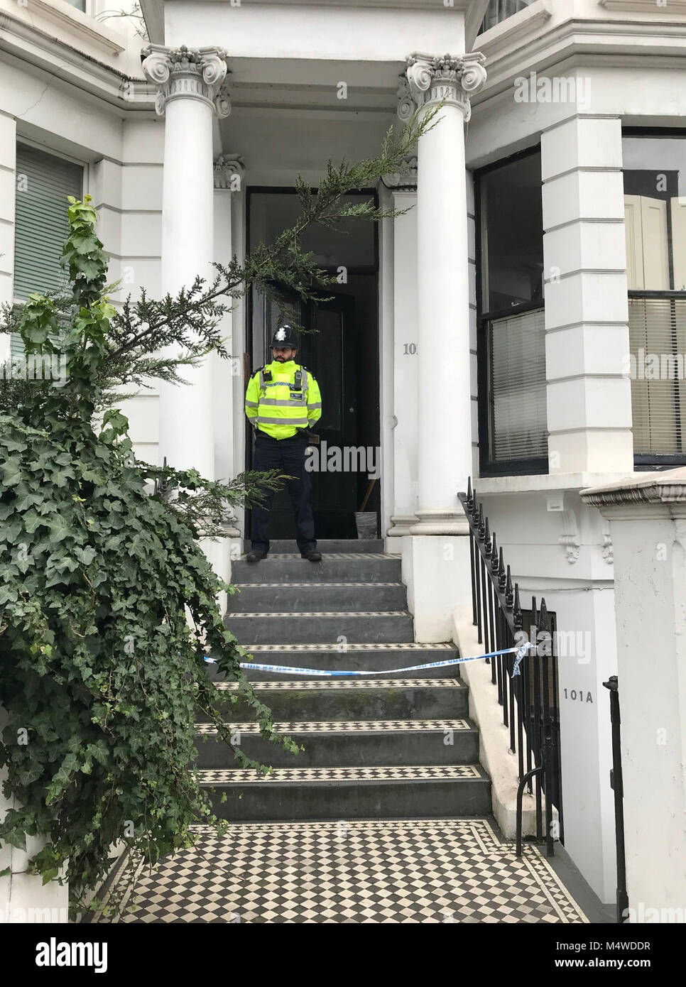 A Police officers outside a house on Earls Court Road, Kensington, west