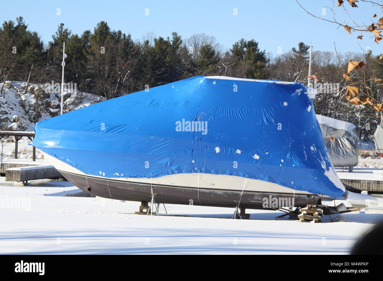 Plastic shrink wrap on boat, to protect boat and interior of boat from