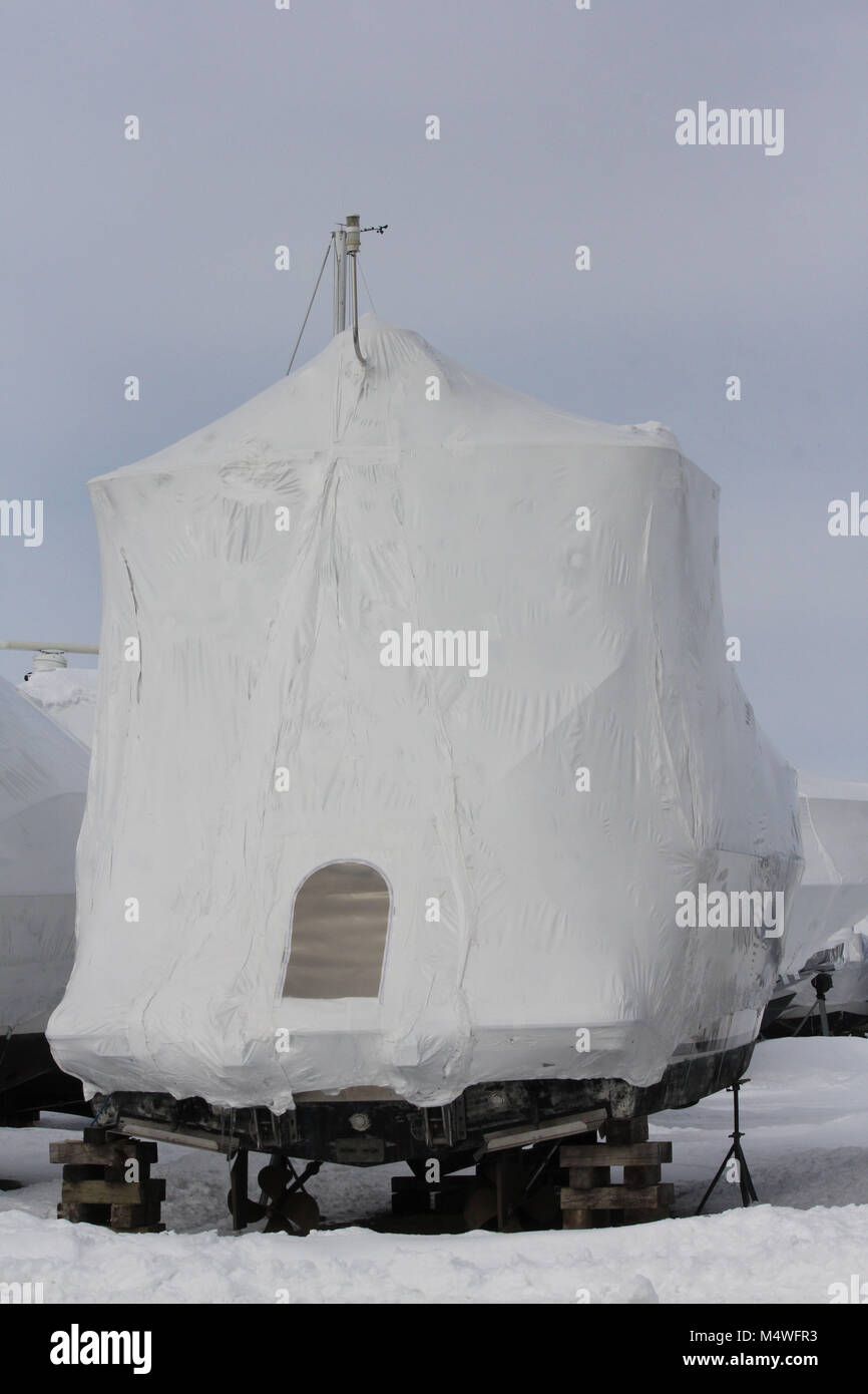 Plastic shrink wrap on boat, to protect boat and interior of boat from the winter elements Stock