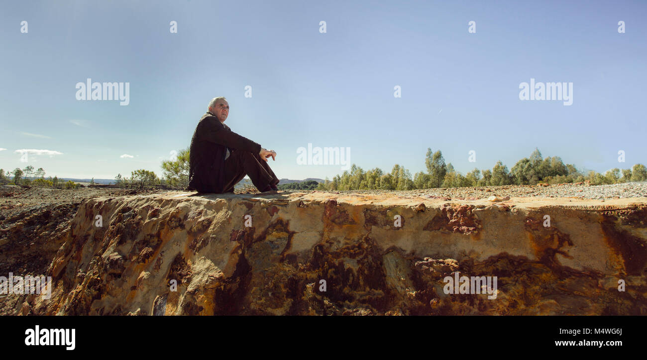 Elderly man sitting on the floor Stock Photo - Alamy