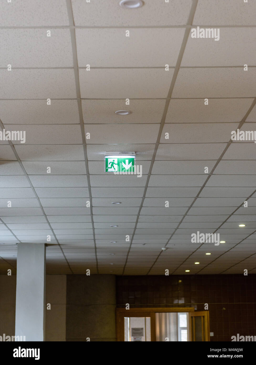 Exit Sign In Hall interior elements in large hall. green exit sign on the sealing Stock ...