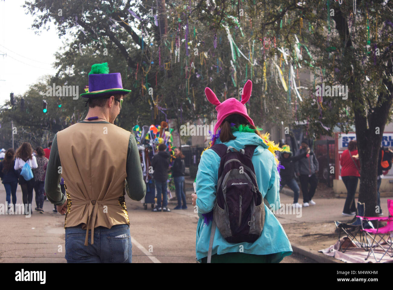 Teenage couple in costumes saunter down St. Charles Ave. on Mardi Gras day.  New Orleans, LA. Stock Photo