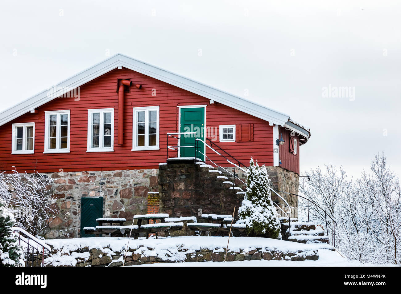 Odderoya in Kristiansand, Norway - January 17, 2018: Krutthuset, the old, red powder house from 1697. Winter, snow on the ground. Stock Photo