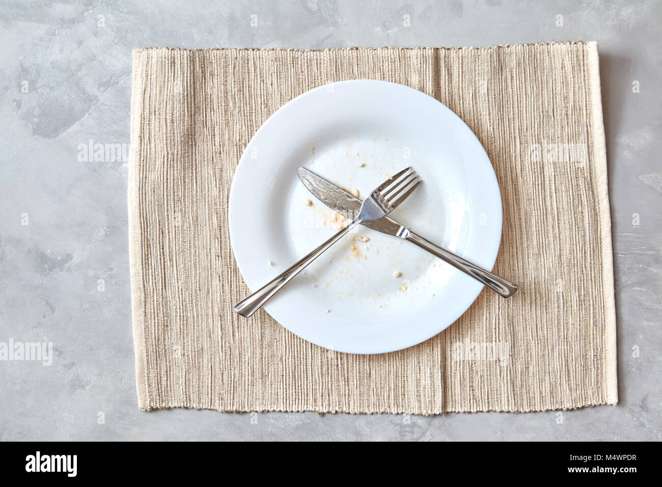 Metal fork and knife on a stone table. arrangement of cutlery after