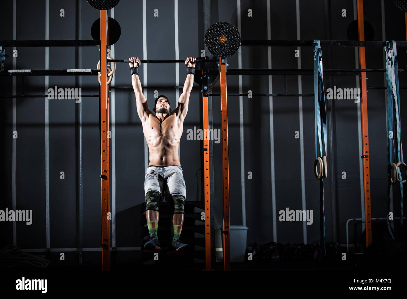 Athletic man works out at the gym with the bar Stock Photo