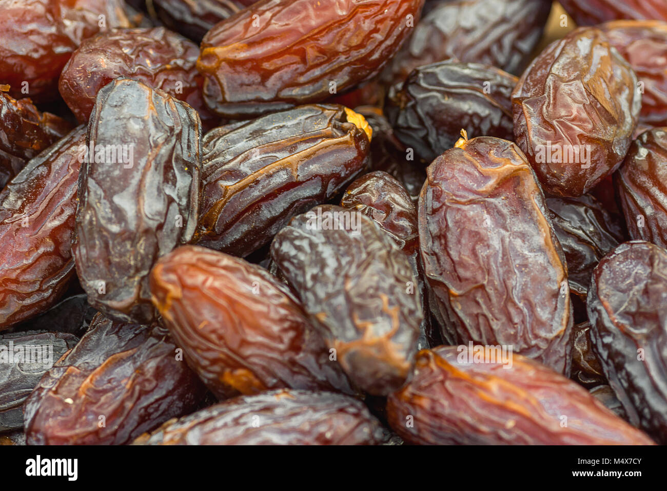 Heap of Ripe Dried Large Brown Dates at Farmers Market. Vibrant Color. Organic Produce Healthy Plant Based Diet Concept. Stock Photo