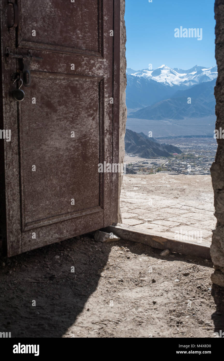 A view of the Zanscar mountain range, through an open door, overlooking Leh, Ladakh. India. Stock Photo