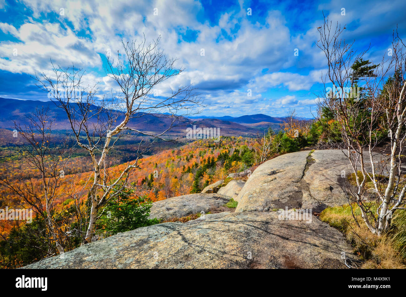 Scenic overlook on granite boulders with view of Adirondack Mountains. Stock Photo