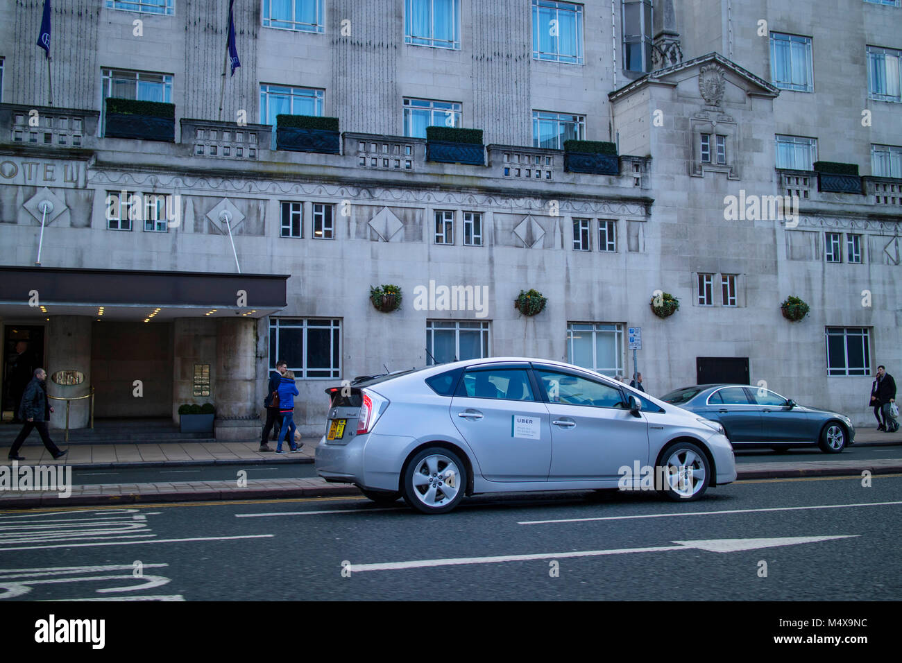 Silver Toyota Prius Uber taxi in Leeds city centre Stock Photo