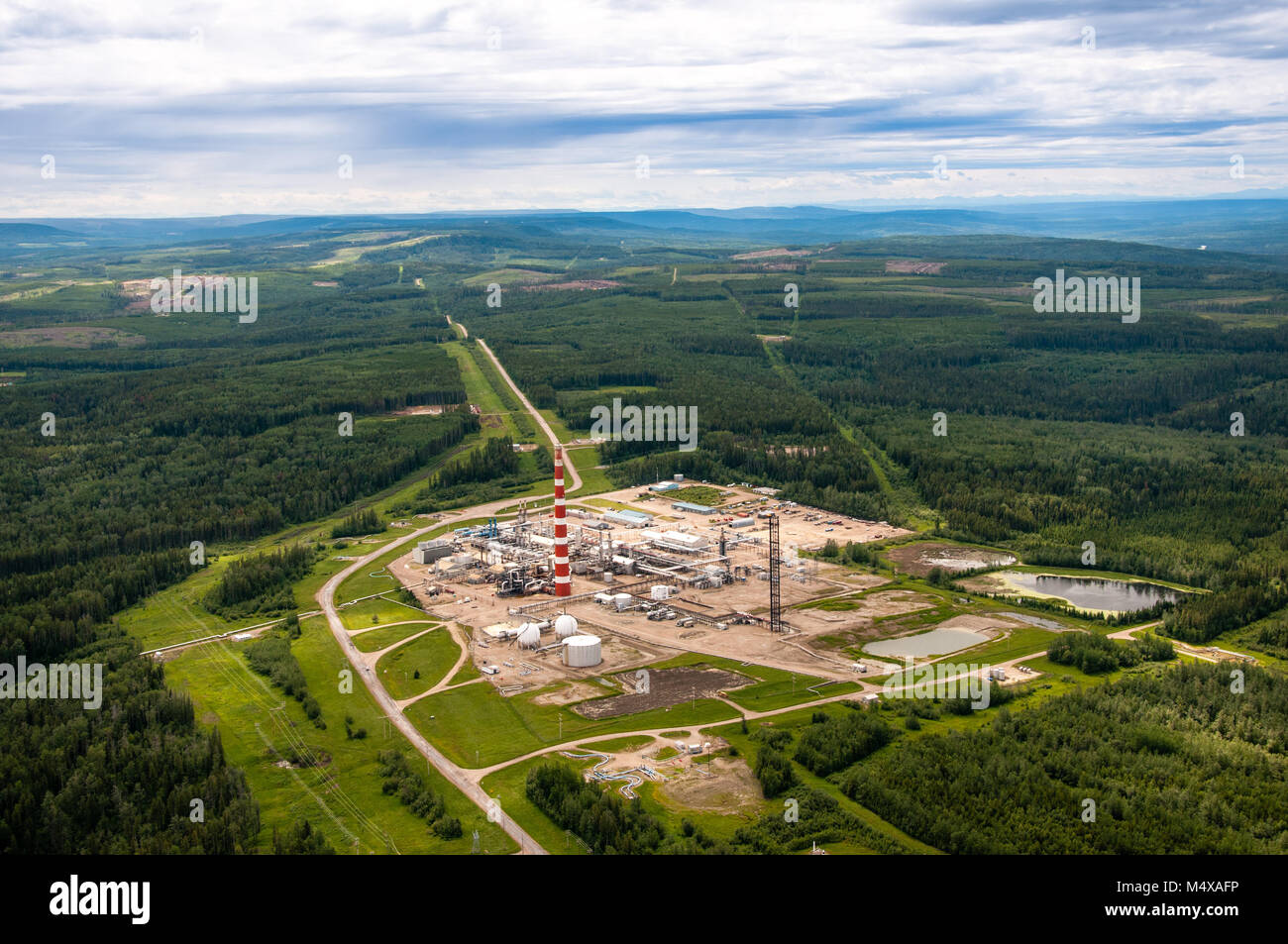 Gas plant in the foothills of Alberta Canada. Rocky Mountains in the