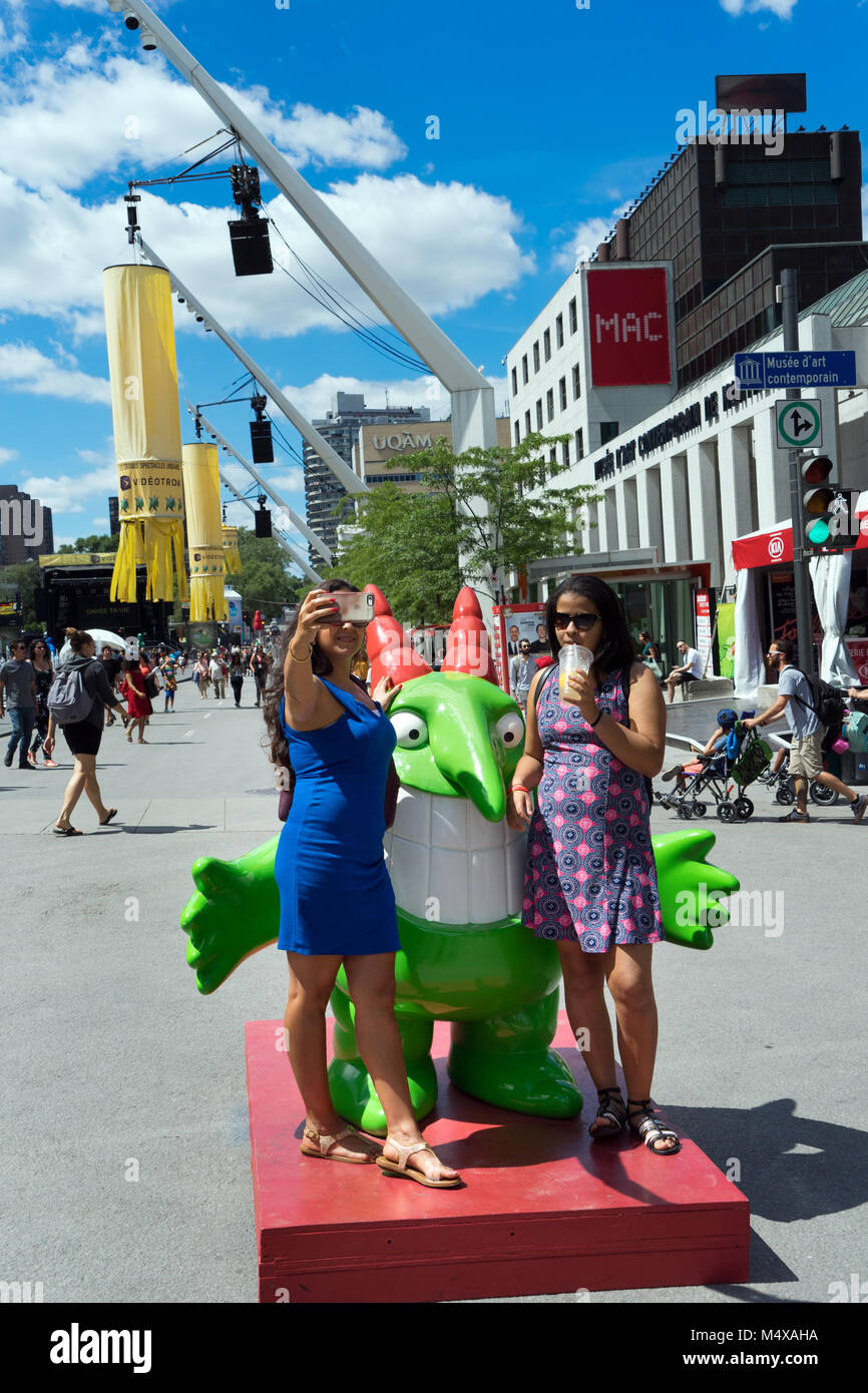 People taking  a picture with Victor, mascot of the Just for Laughs festival in Montreal, province of Quebec, Canada. Stock Photo