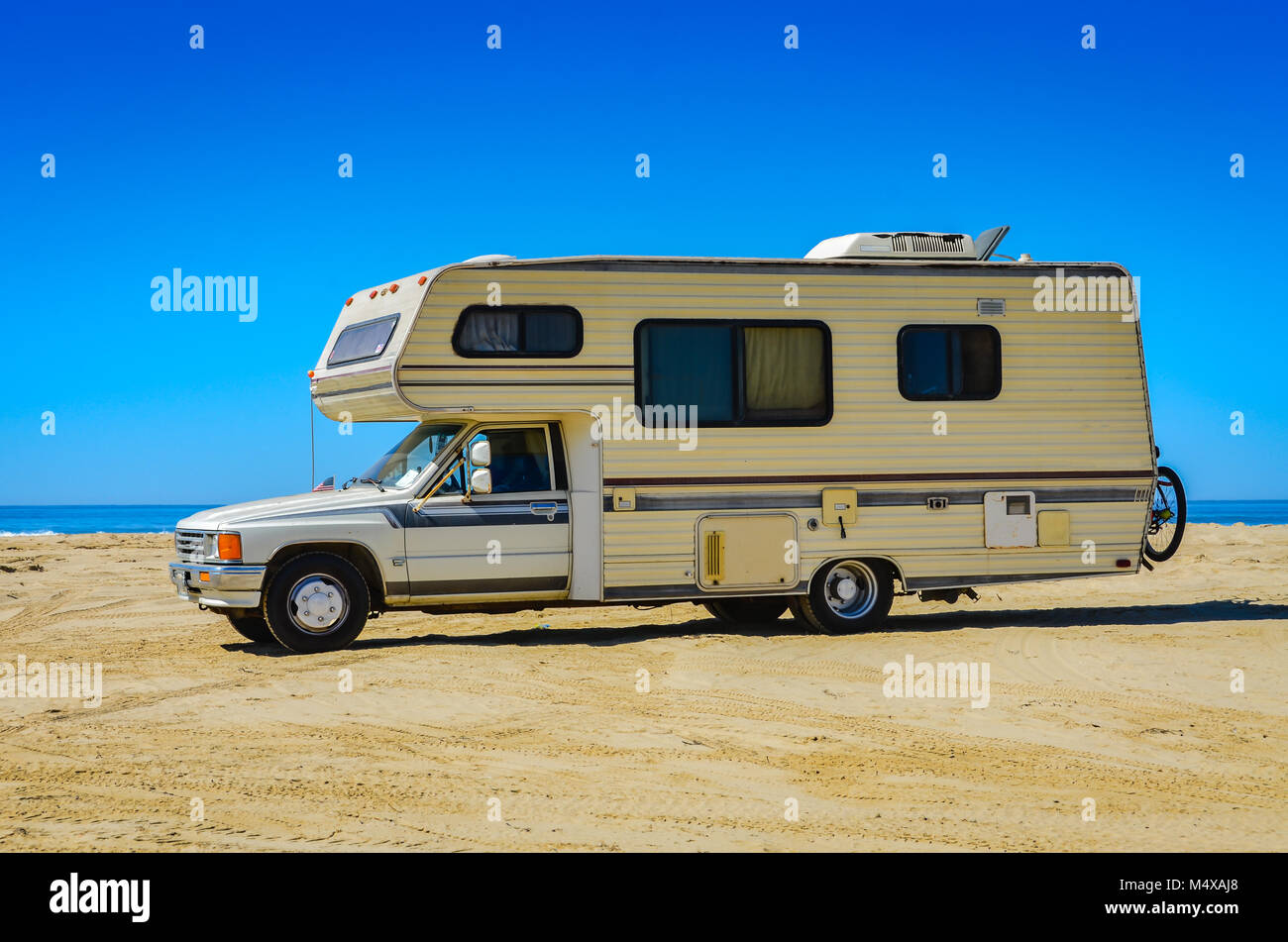 Camper van recreational vehicle on the beach shore at the Oceano Dunes in San Luis Obispo, CA. Stock Photo
