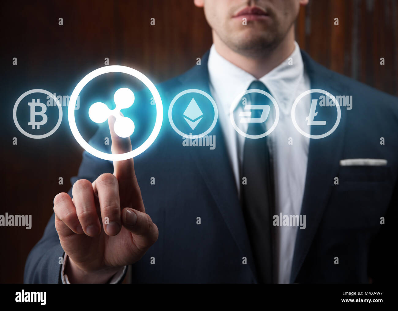 Businessman pressing ripple icon choosing from other cryptocurrency. Bitcoin, ripple, litecoin, dash, ethereum Stock Photo