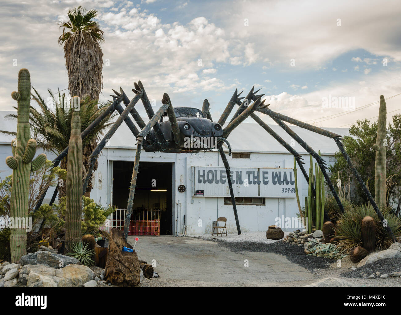 Roadside attraction in the Mojave Desert features a giant black spider welded together with a Volkswagon Bug car at the center. Stock Photo