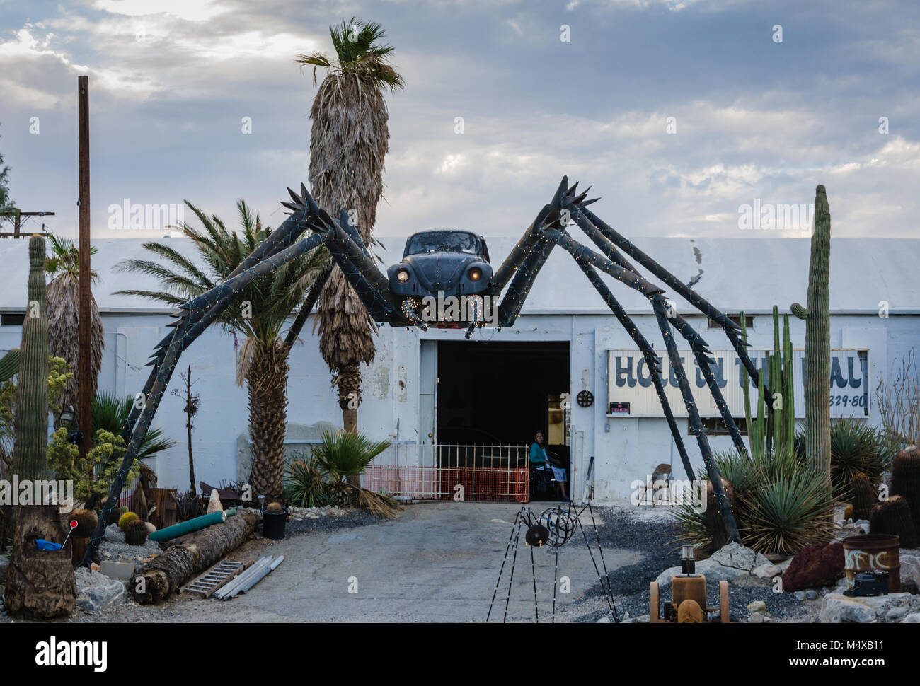 Roadside attraction in the Mojave Desert features a giant black spider welded together with a Volkswagon Bug car at the center. Stock Photo