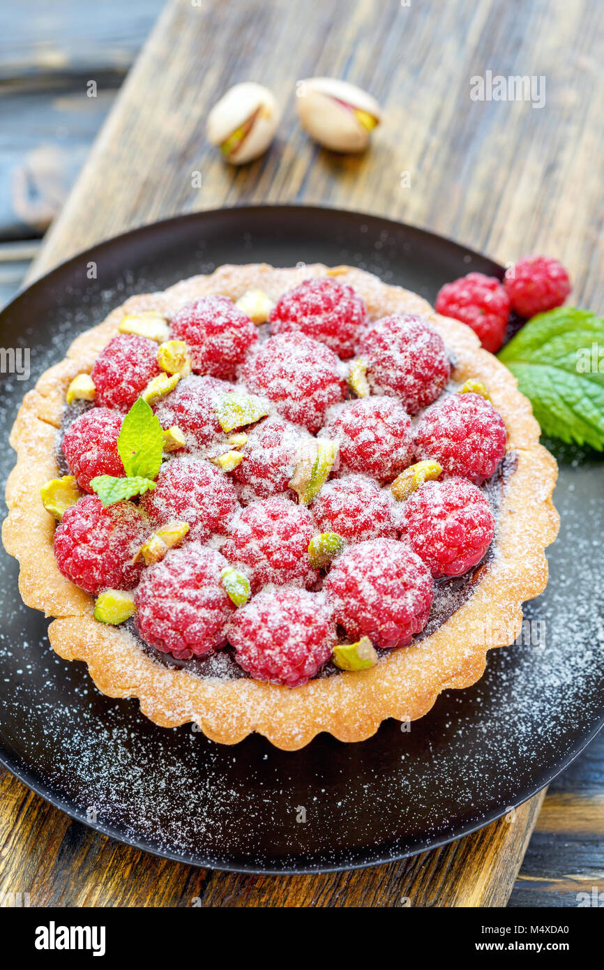 Delicious mini tart with fresh raspberries. Stock Photo