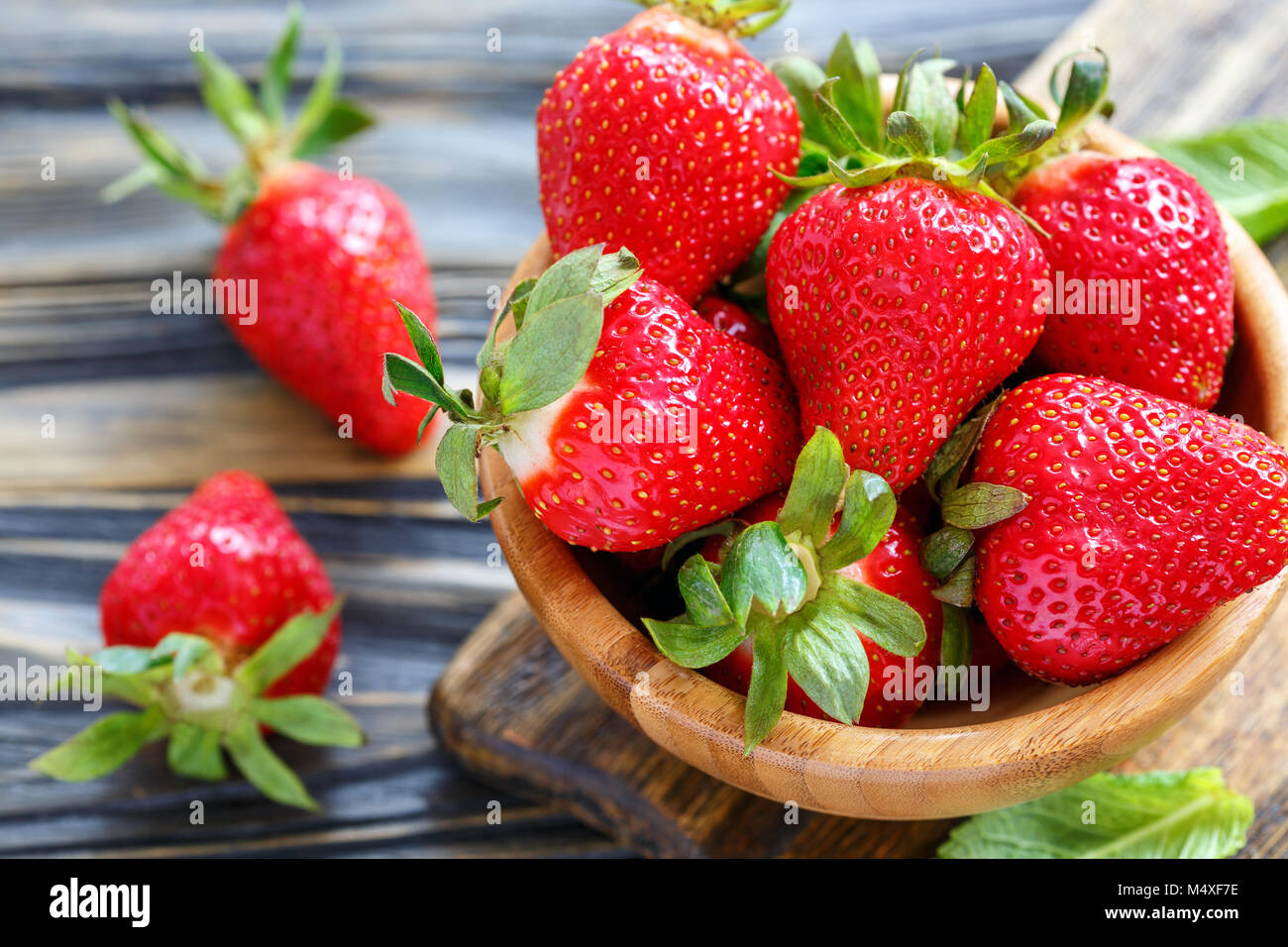Ripe strawberry in a wooden bowl Stock Photo - Alamy