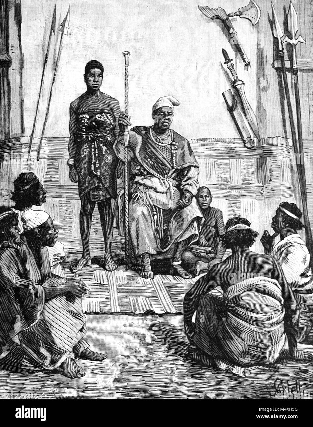 Tribal King, Don Manual, in the Village of Mussera or Musserra, northern Angola. The area was formerly part of the Kingdom of Congo (1390-1891) inhabited mainly by Kongo or Bakongo People from the Valley of Congo or Zaire (Engraving, 1888) Stock Photo