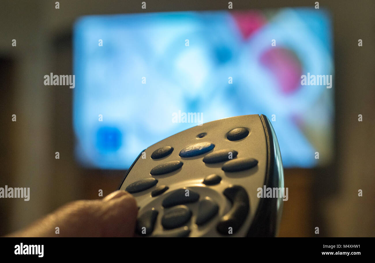 Close-up of a Sky TV remote control being used in a living room, United Kingdom. Stock Photo