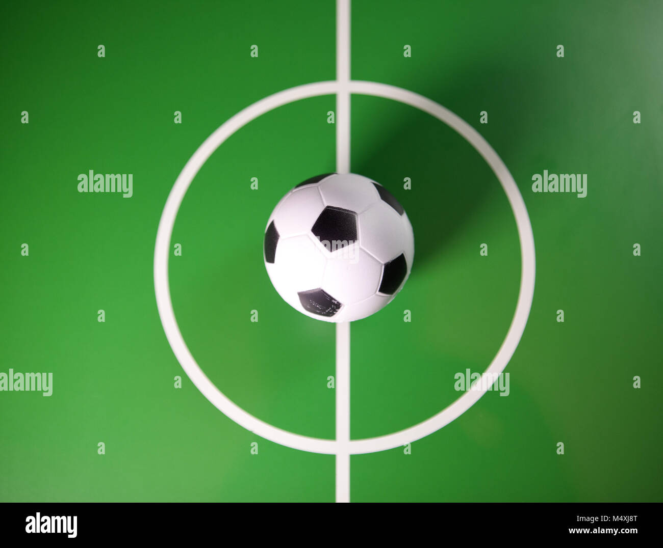 Toy soccerball in a midfield Stock Photo