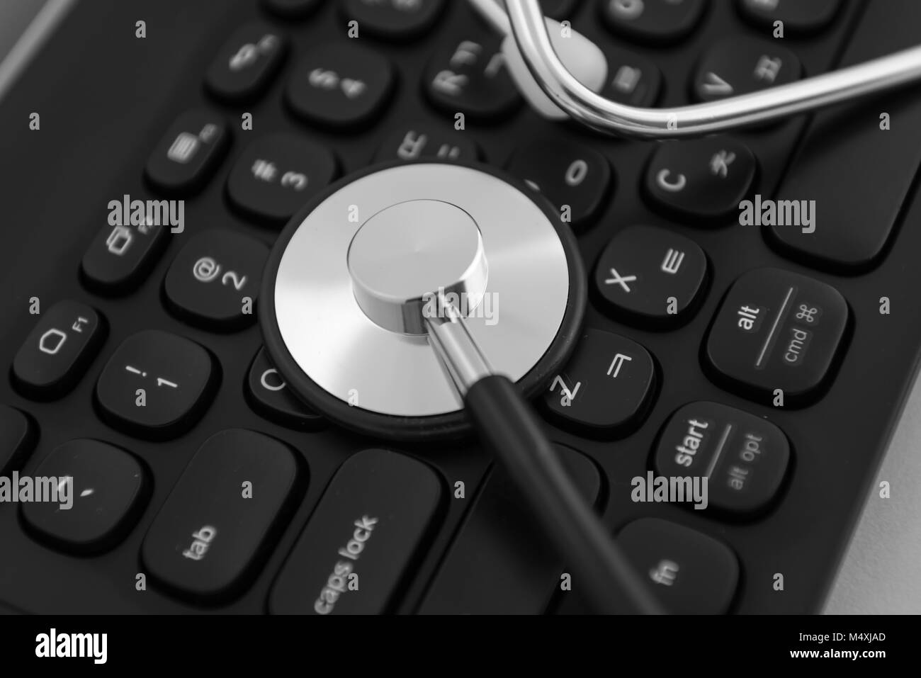 Stethoscope isolated on white with a modern Korean Computer Keyboard Stock Photo