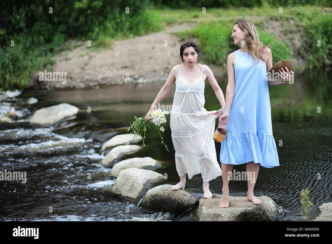 Beautiful girls in dresses on the river Stock Photo - Alamy