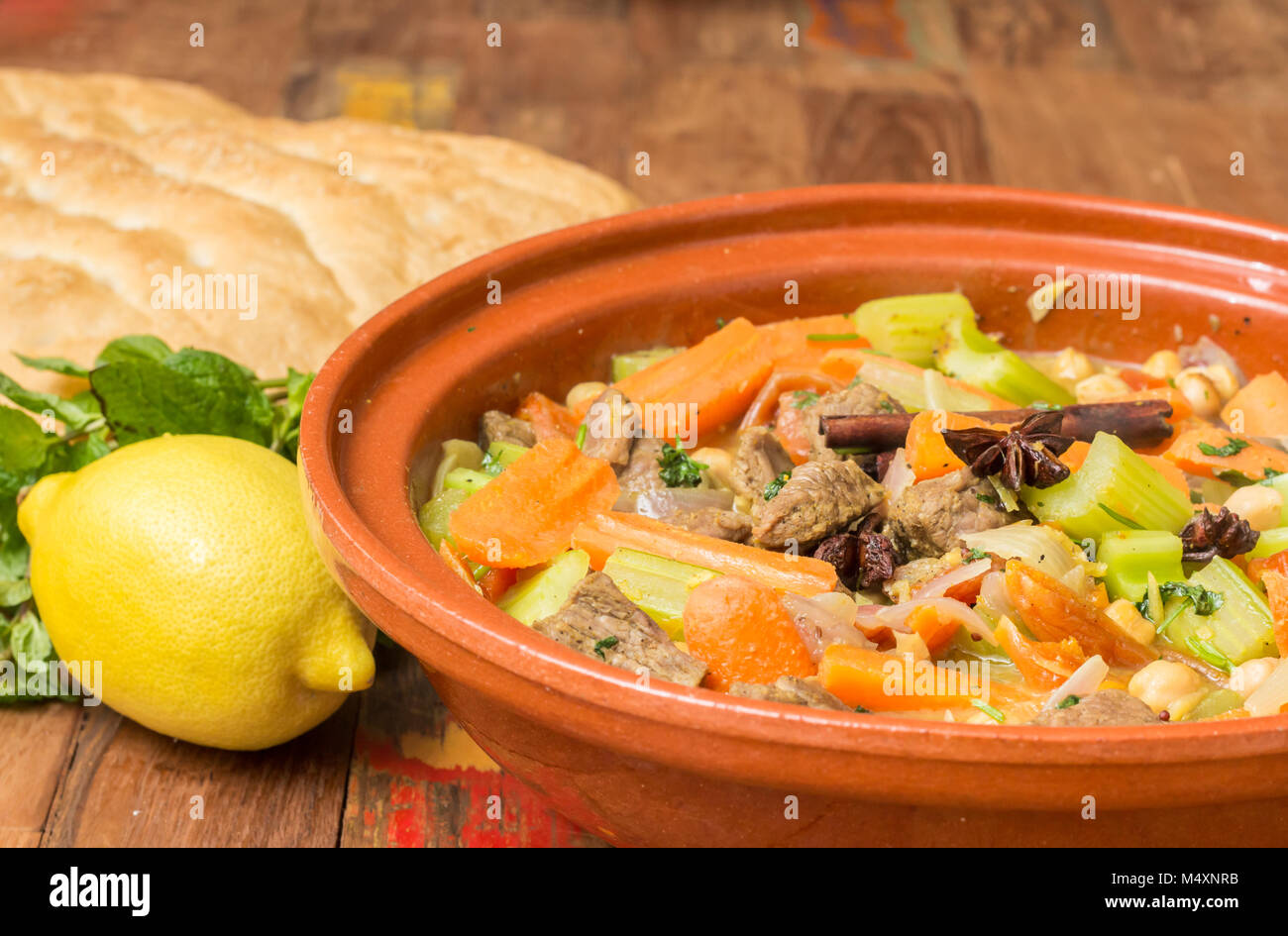 Moroccan tagine dish with chick peas, lamb, carrots, celery, lemon