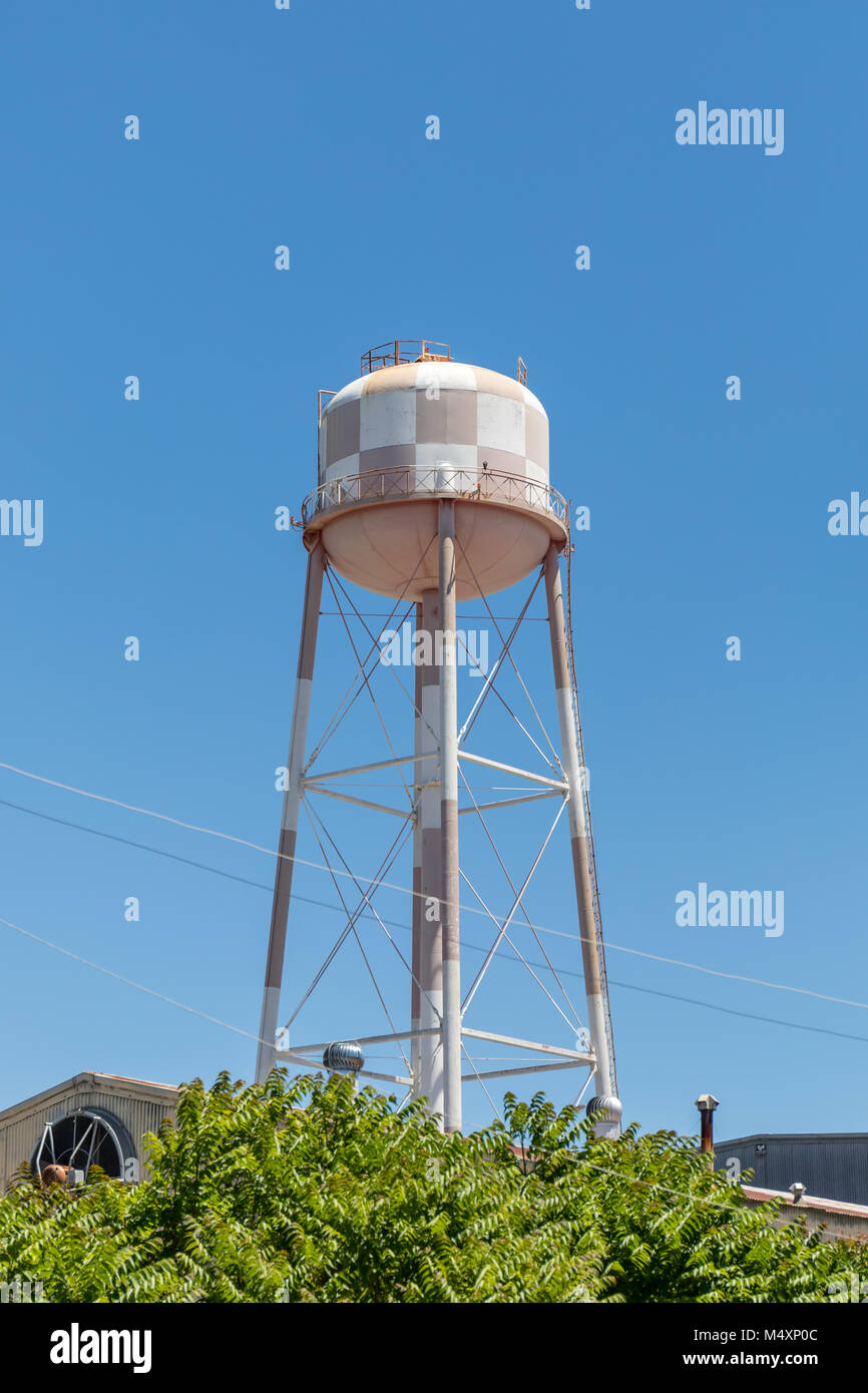 Water tower, white and red, against a bluer sky; Sunnyvale, California Stock Photo