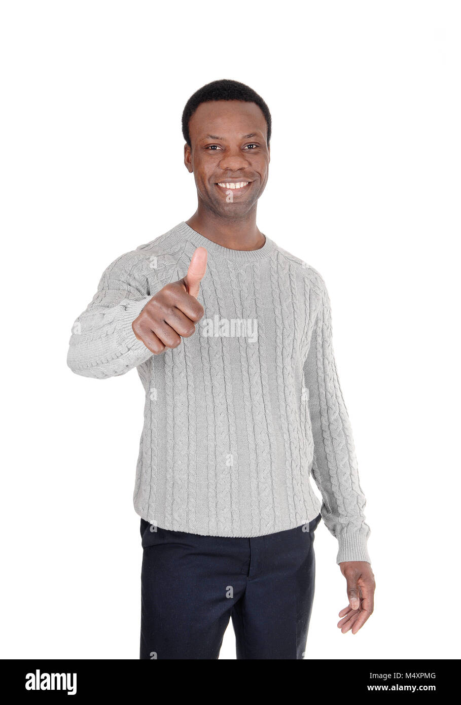 A young African American man in a gray sweater with one hand sign thumps up and smiling, isolated for white background Stock Photo
