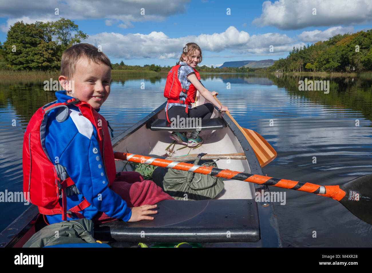 Family canoeing the Garavogue River to Lough Gill, Sligo town, County Sligo, Ireland. Stock Photo