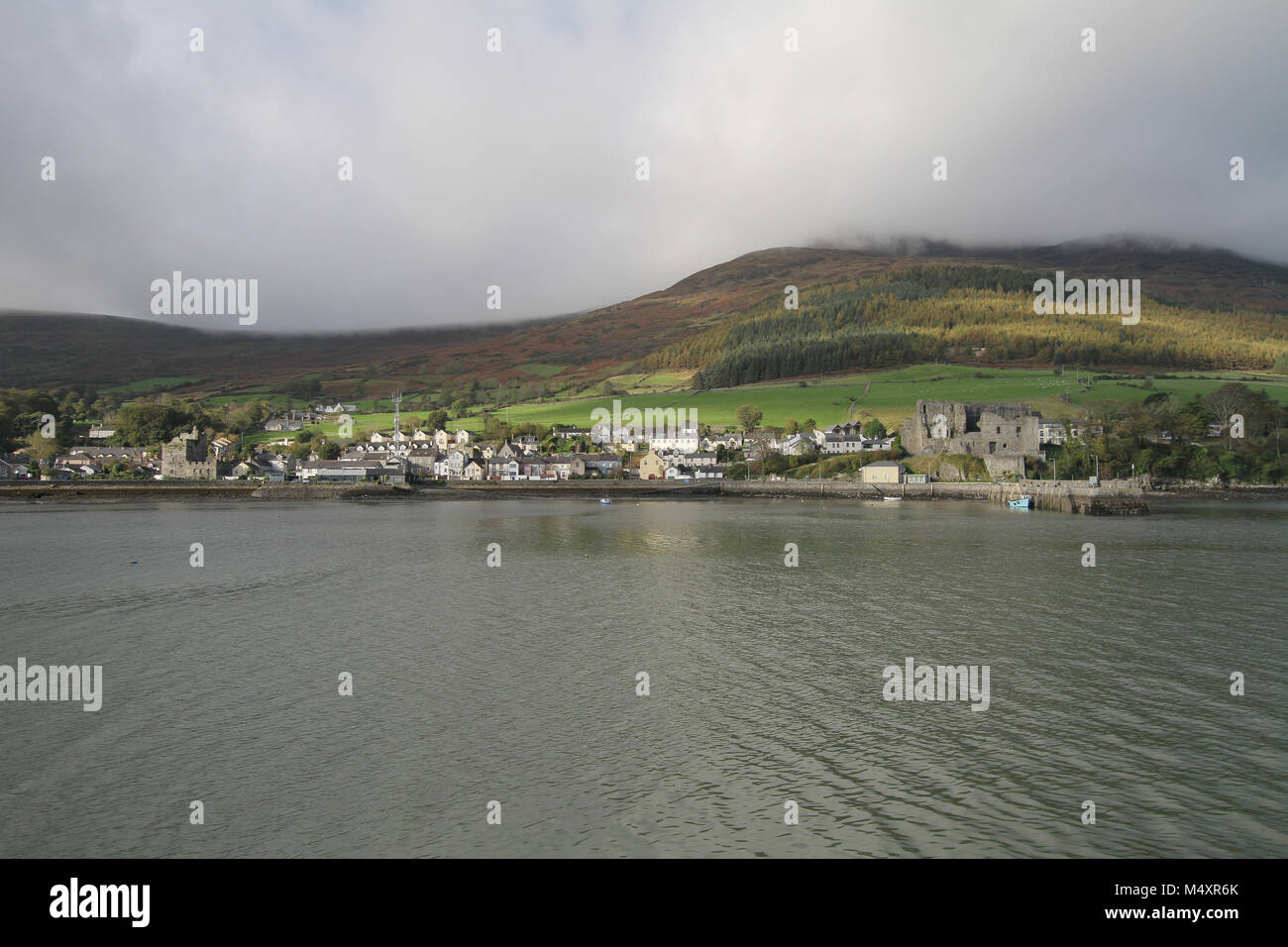 The town and harbour at Carlingford, County Louth, Ireland. Slieve Foy overlooking Carlingford is covered in mist. Stock Photo