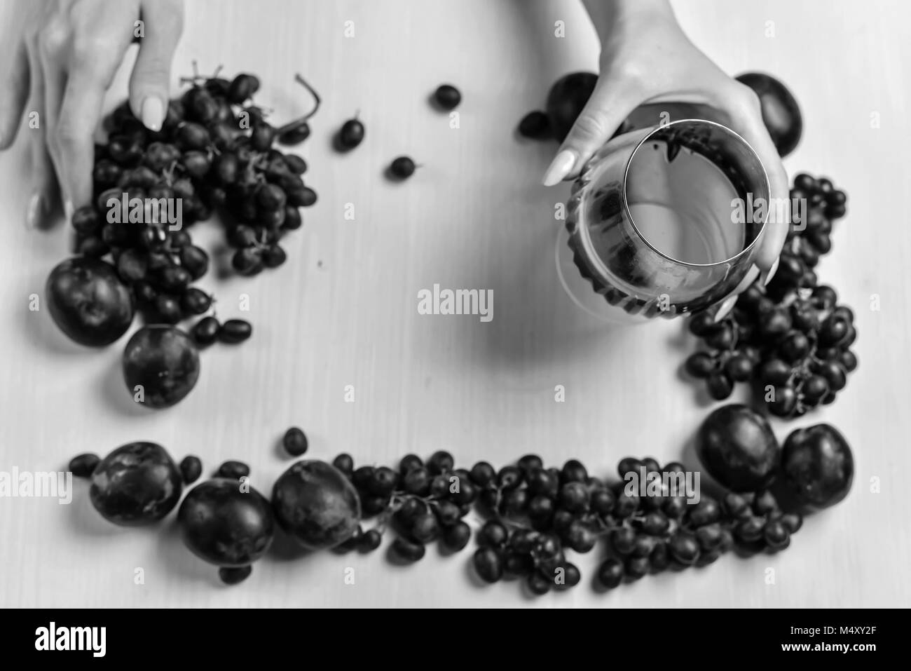 composition of wine, grape and plums black and white poster Stock Photo