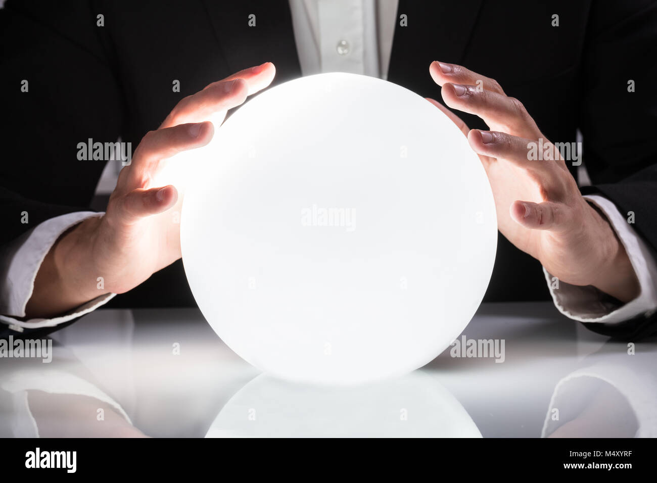 Close-up Of Businessman Hand On Crystal Ball Stock Photo - Alamy